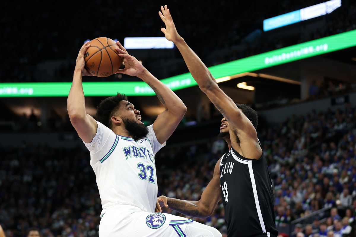 Minnesota Timberwolves center Karl-Anthony Towns (32) shoots as Brooklyn Nets center Nic Claxton (33) defends during the first half at Target Center in Minneapolis on Feb. 24, 2024.